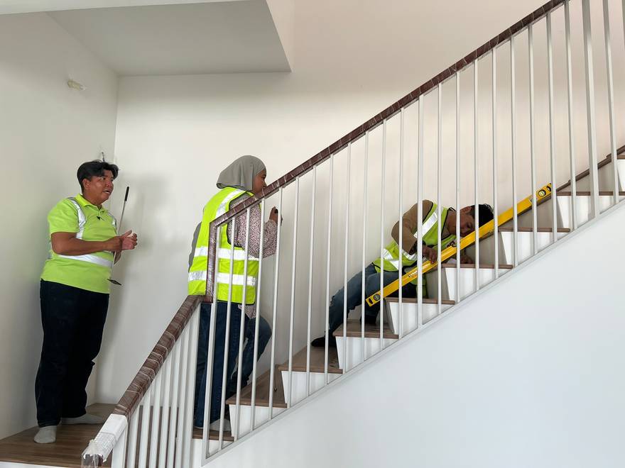 Canaan inspection team checking staircase workmanship during a home defect inspection in Malaysia